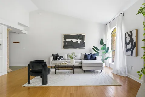 a living room with furniture and wooden floor