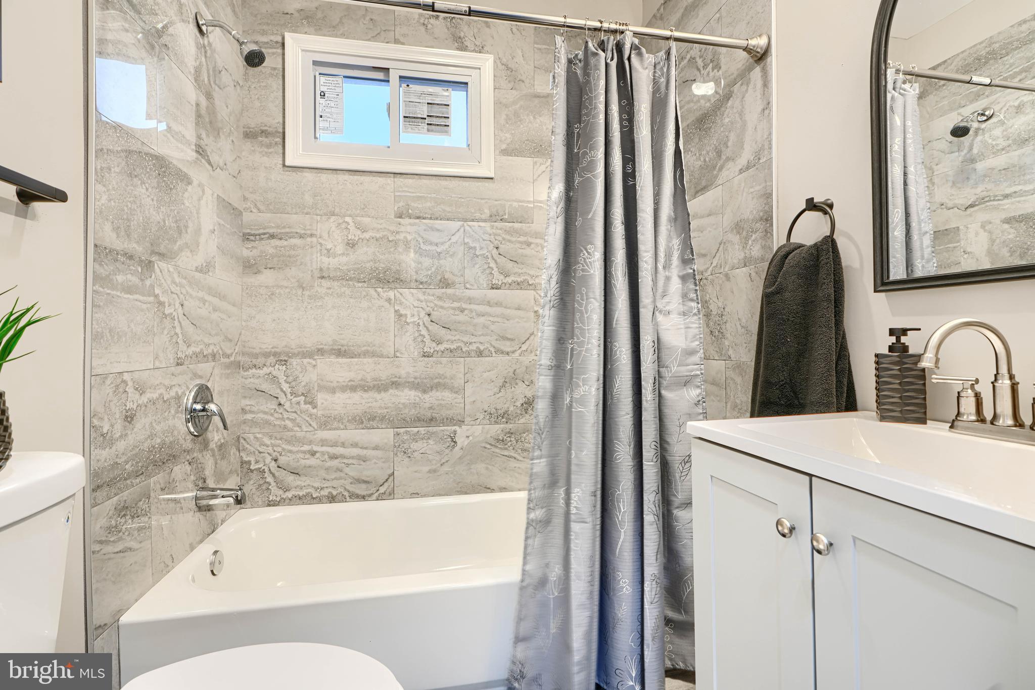 717 East Biddle Street Baltimore, MD 21202 - Photo 36 of 47 a bathroom with a sink a bathtub and a shower