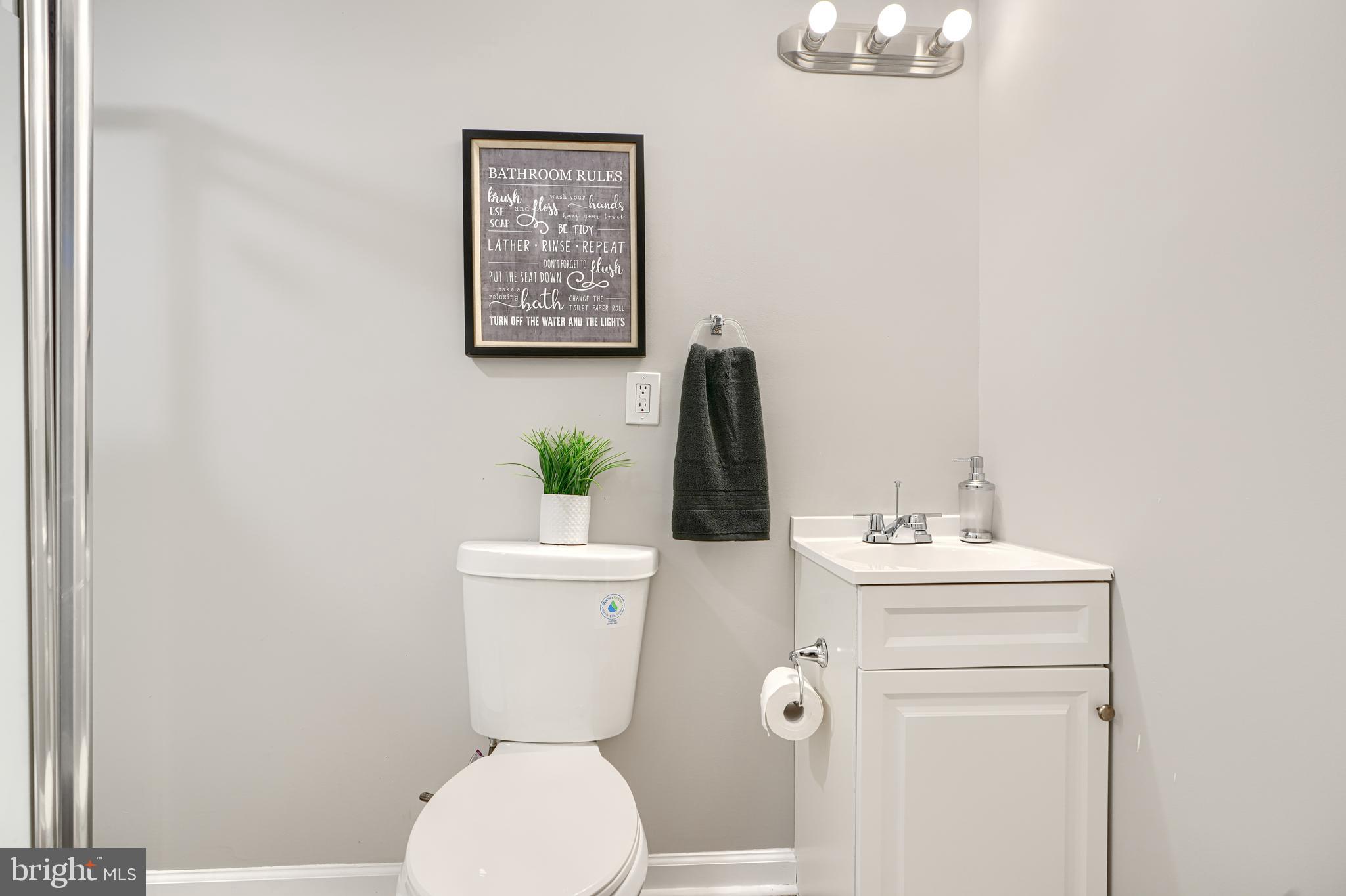 717 East Biddle Street Baltimore, MD 21202 - Photo 41 of 47 a bathroom with a toilet a sink and mirror