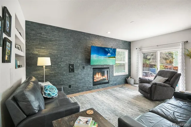 a living room with furniture and a fireplace