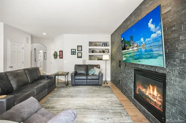 a living room with furniture and a fireplace