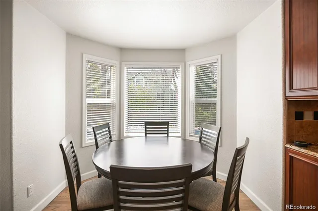 a view of a dining room with furniture window and wooden floor