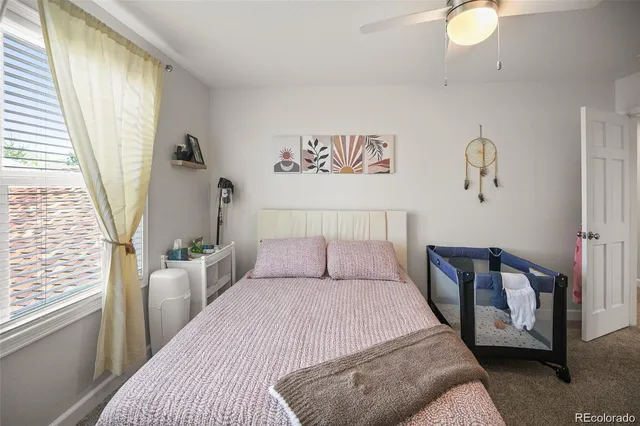 a bedroom with a large bed and a window