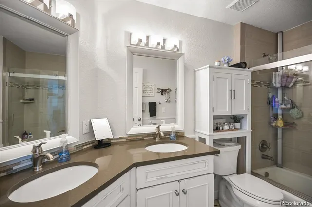 a bathroom with a sink double vanity granite and a mirror