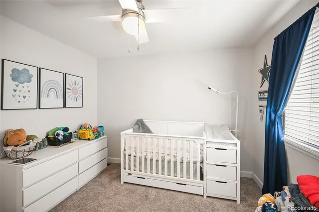 a bedroom with a baby bed baby crib and a window