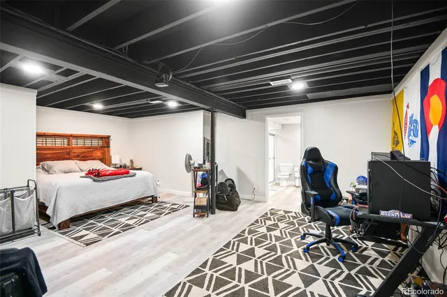 a bed room with a bed and a television