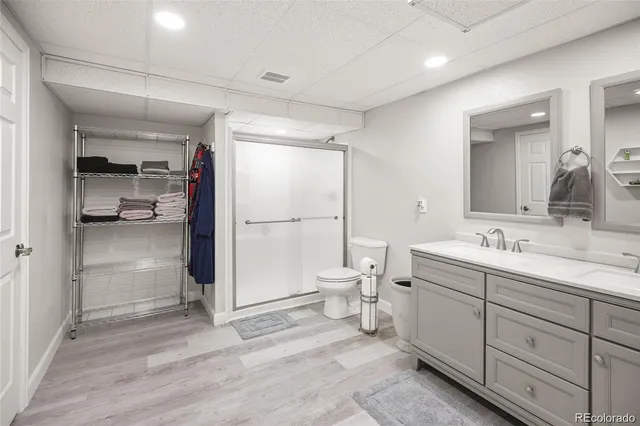 a bathroom with a granite countertop sink mirror and toilet