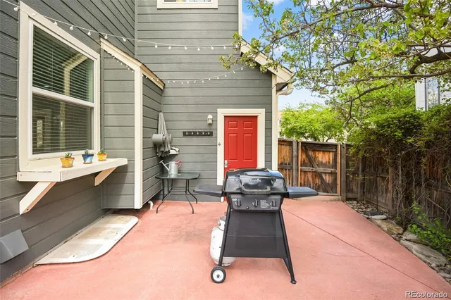 a backyard view of a house with outdoor seating