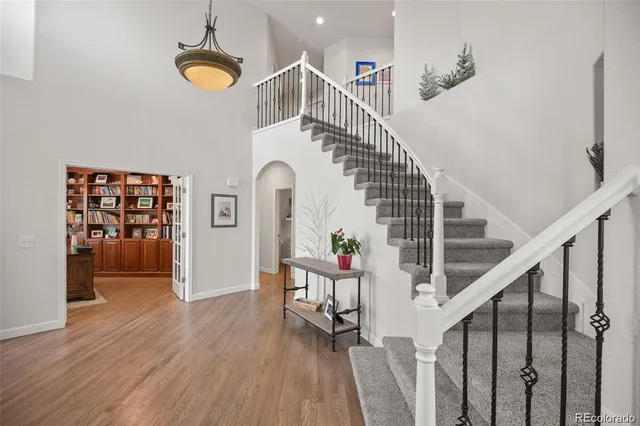 a view of entryway and hall with wooden floor