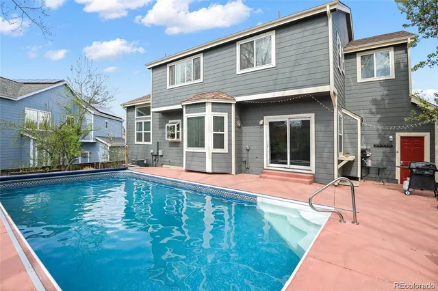 a house with swimming pool in front of it