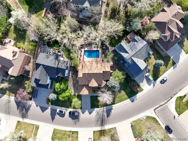 an aerial view of a house with a yard and garden