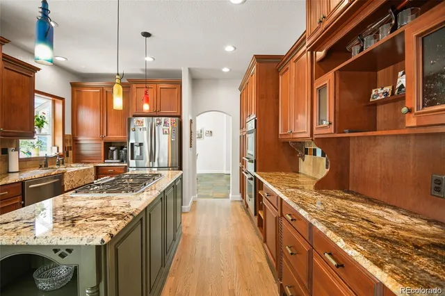 a large kitchen with kitchen island granite countertop a large window
