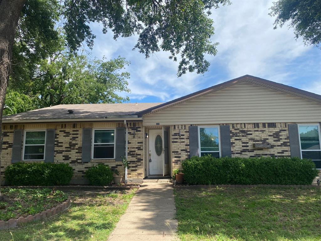 1109 Cross Bend Road Plano, TX 75023 - Photo 1 of 11 Brick facade featuring a peaked roofline, vinyl siding, and decorative window shutters