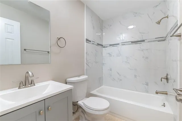 a view of a livingroom with wooden floor and a ceiling fan