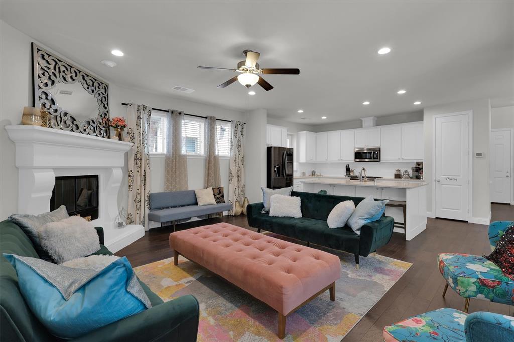 4504 Del Rey Avenue McKinney, TX 75070 - Photo 12 of 40 a living room with furniture and a fireplace