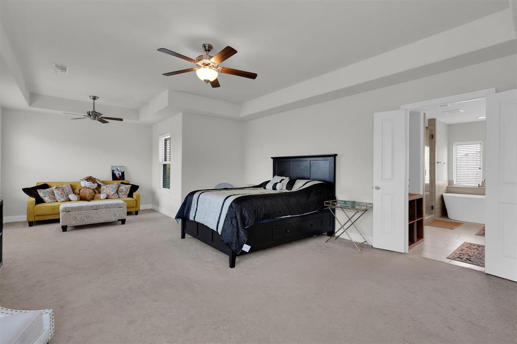 4504 Del Rey Avenue McKinney, TX 75070 - Photo 15 of 40 a bedroom with furniture and a large mirror
