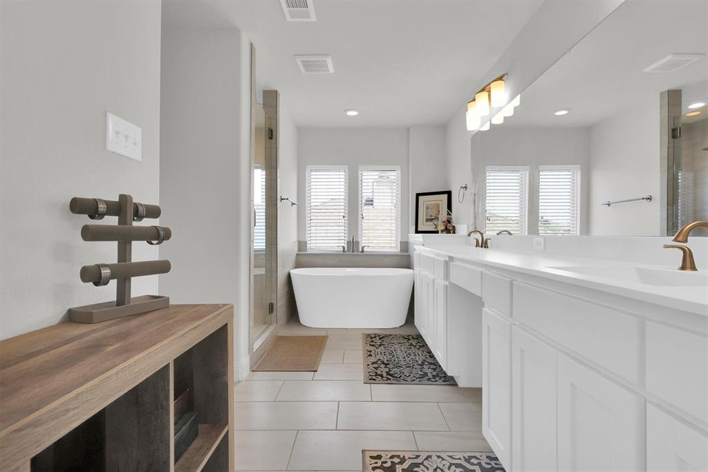 4504 Del Rey Avenue McKinney, TX 75070 - Photo 17 of 40 a bathroom with a sink a toilet a mirror and shower