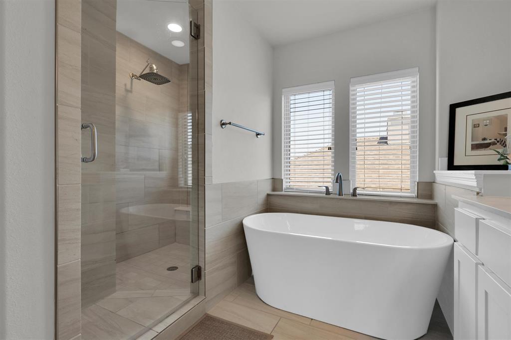 4504 Del Rey Avenue McKinney, TX 75070 - Photo 18 of 40 a white bath tub sitting in a bathroom next to a window