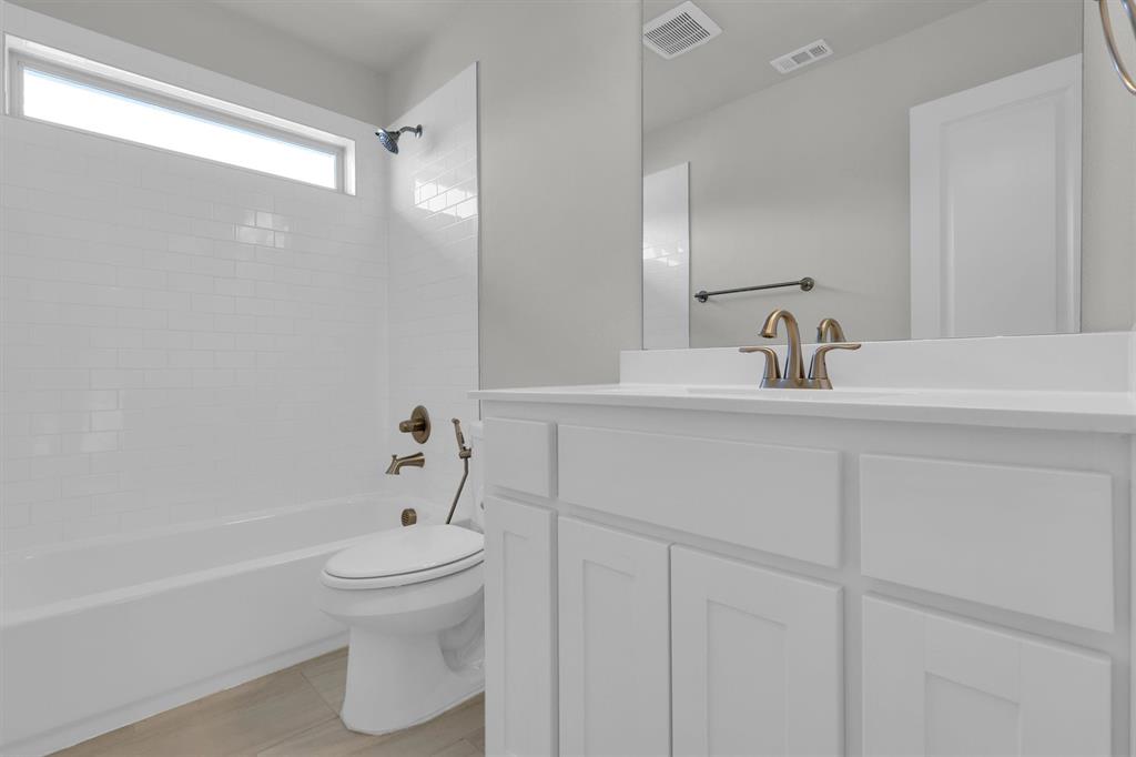 4504 Del Rey Avenue McKinney, TX 75070 - Photo 23 of 40 a bathroom with a sink toilet and shower