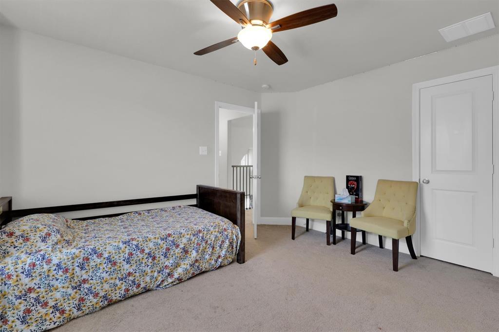 4504 Del Rey Avenue McKinney, TX 75070 - Photo 25 of 40 a bedroom with a bed and a chair
