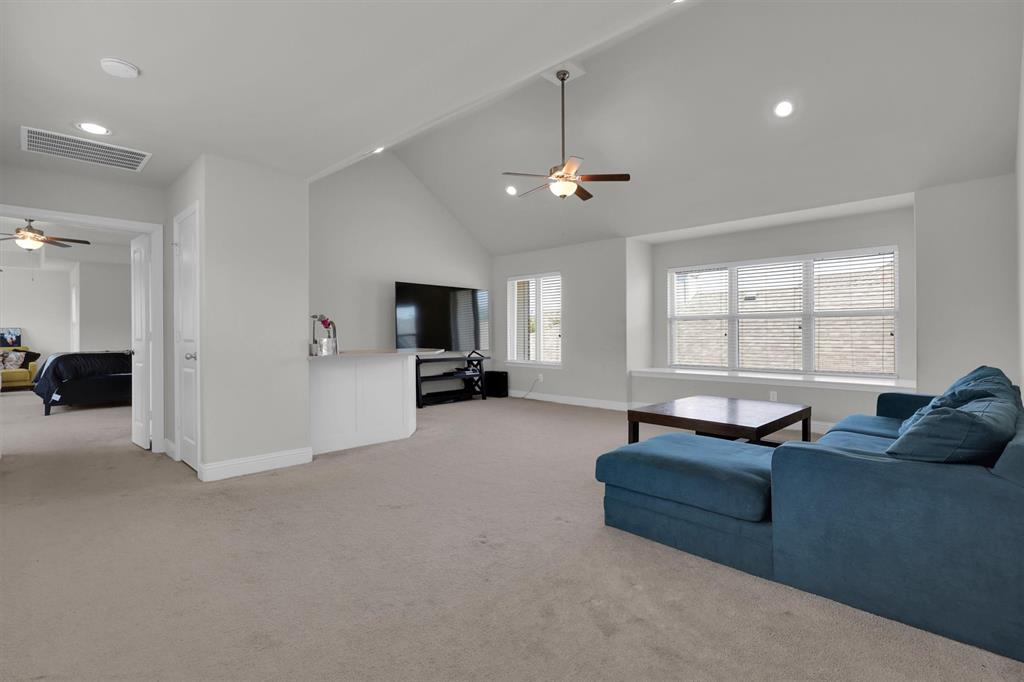 4504 Del Rey Avenue McKinney, TX 75070 - Photo 28 of 40 a living room with furniture and a flat screen tv