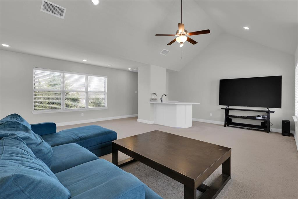 4504 Del Rey Avenue McKinney, TX 75070 - Photo 29 of 40 a living room with furniture and a flat screen tv