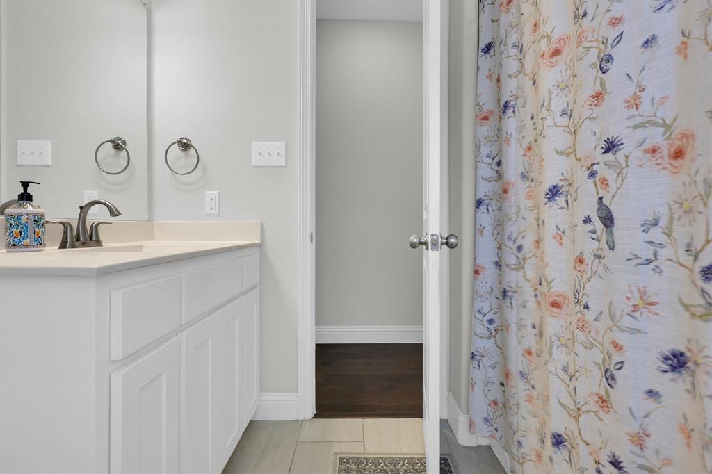 4504 Del Rey Avenue McKinney, TX 75070 - Photo 31 of 40 a bathroom with a sink and a mirror