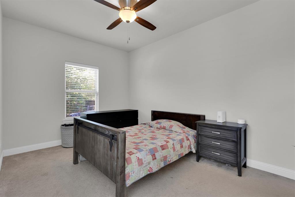 4504 Del Rey Avenue McKinney, TX 75070 - Photo 33 of 40 a bedroom with a bed and a chandelier