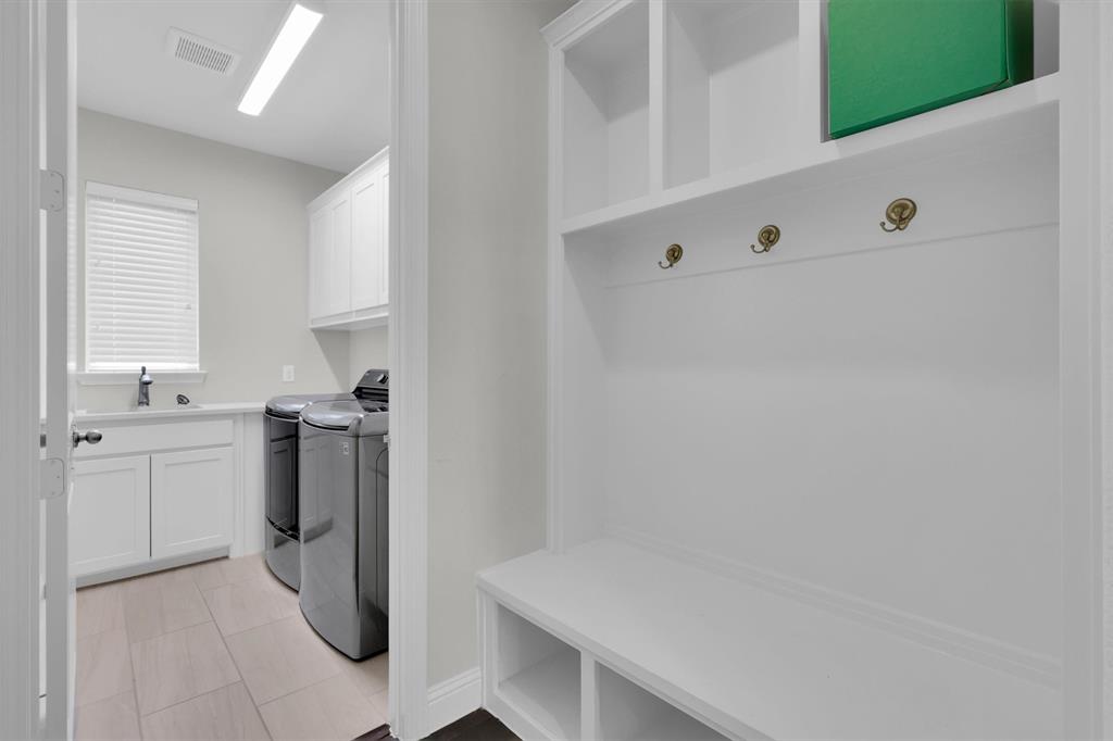 4504 Del Rey Avenue McKinney, TX 75070 - Photo 34 of 40 a utility room with cabinets washer and dryer