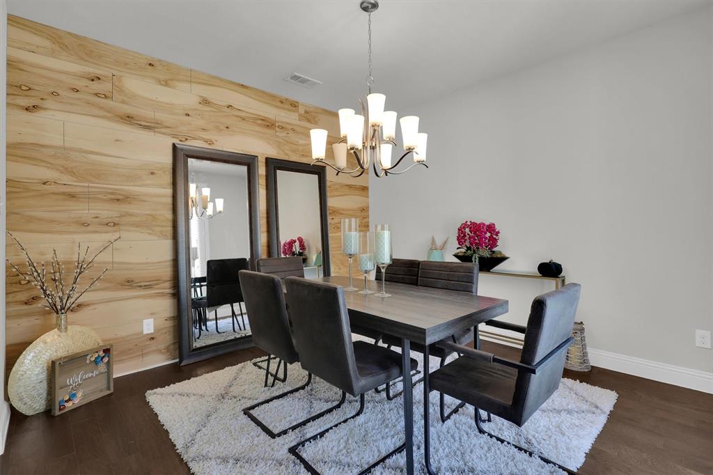 4504 Del Rey Avenue McKinney, TX 75070 - Photo 7 of 40 a view of a dining room with furniture and chandelier