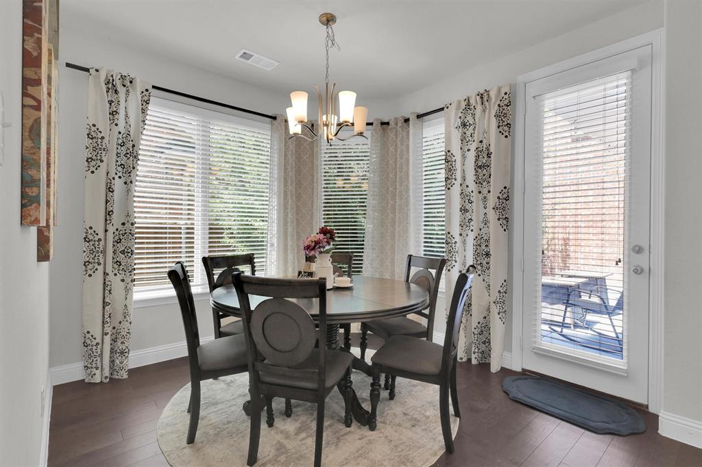 4504 Del Rey Avenue McKinney, TX 75070 - Photo 9 of 40 a view of a dining room with furniture window and wooden floor