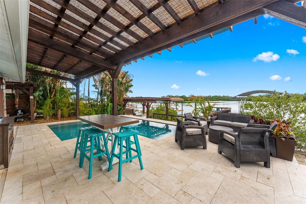 29 Pelican Lane Edgewater, FL 32141 - Photo 22 of 39 a view of a patio with swimming pool table and chairs