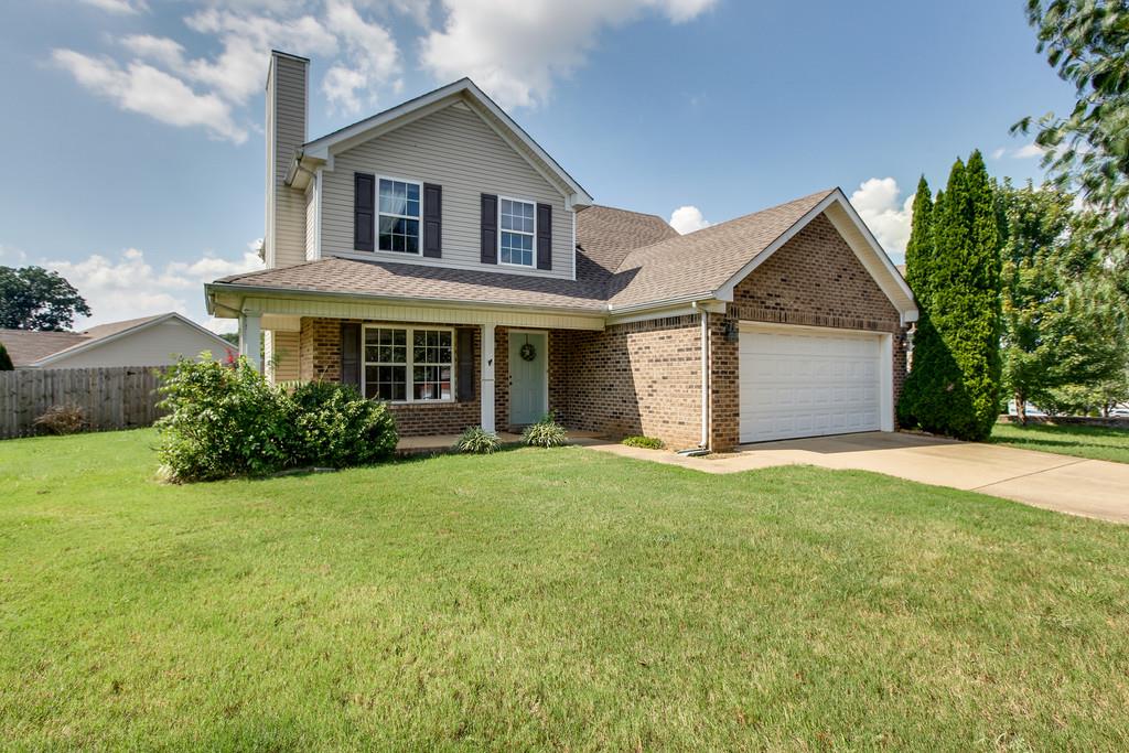 1909 Portway Road Spring Hill, TN 37174 - Photo 1 of 30 a front view of a house with a garden and yard