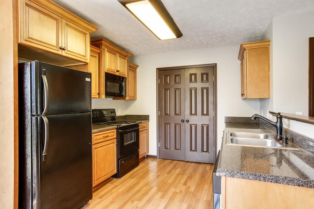 1909 Portway Road Spring Hill, TN 37174 - Photo 13 of 30 a kitchen with granite countertop a refrigerator stove and sink