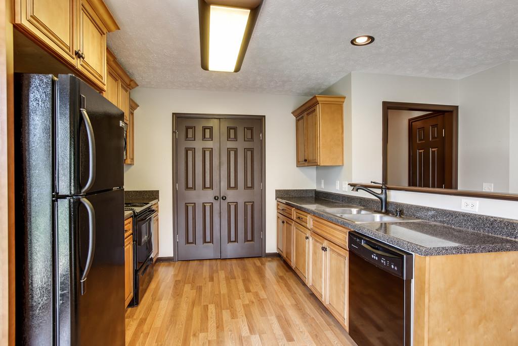 1909 Portway Road Spring Hill, TN 37174 - Photo 14 of 30 a kitchen with stainless steel appliances granite countertop a refrigerator a stove and a sink