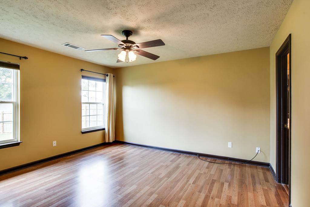 1909 Portway Road Spring Hill, TN 37174 - Photo 16 of 30 a view of an empty room with wooden floor and a window