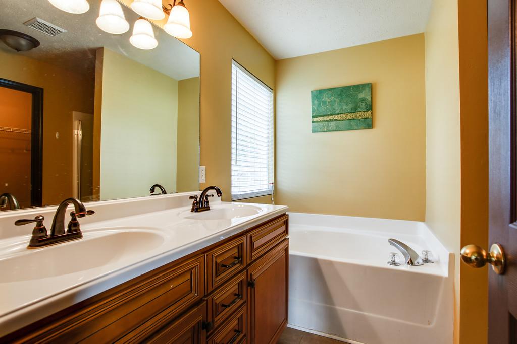 1909 Portway Road Spring Hill, TN 37174 - Photo 20 of 30 a bathroom with a sink a large mirror and a bathtub