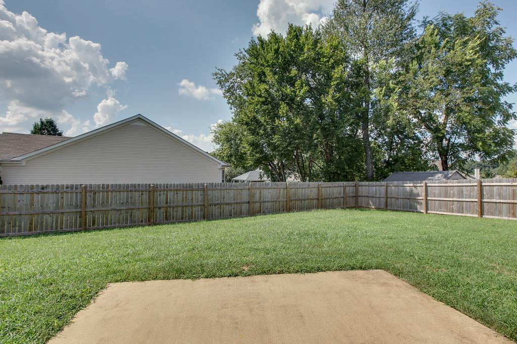 1909 Portway Road Spring Hill, TN 37174 - Photo 27 of 30 a view of a backyard with a garden and wooden fence
