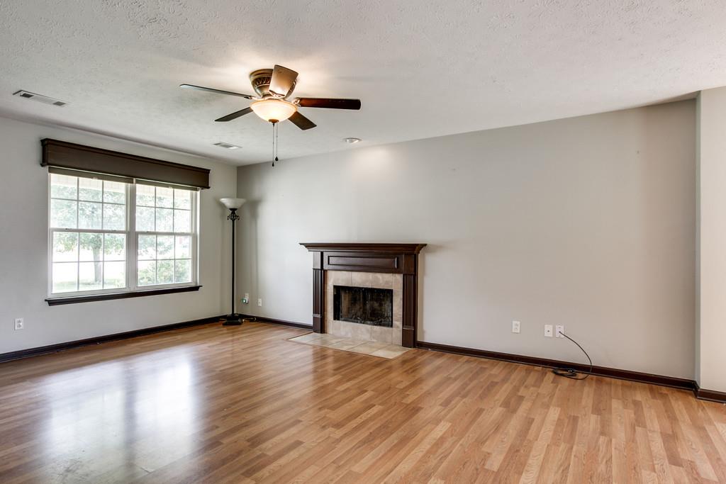 1909 Portway Road Spring Hill, TN 37174 - Photo 8 of 30 a view of an empty room with a window and wooden floor