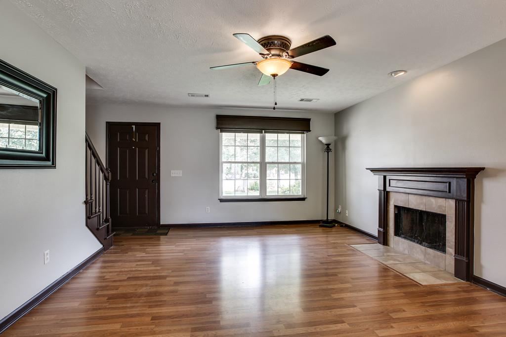 1909 Portway Road Spring Hill, TN 37174 - Photo 9 of 30 a view of an empty room with a window and wooden floor