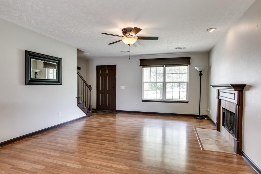 1909 Portway Road Spring Hill, TN 37174 - Photo 10 of 30 a view of an empty room with a window and wooden floor