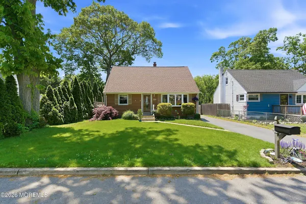 a view of house with backyard and outdoor seating