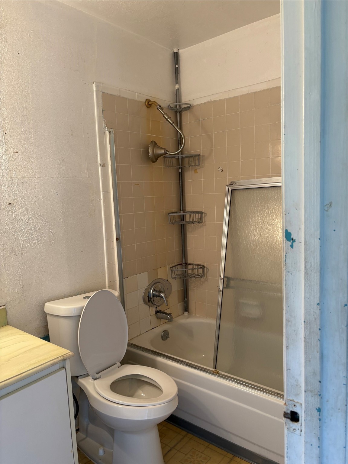2131 Campbell Road Houston, TX 77080 - Photo 19 of 39 a bathroom with a granite countertop toilet and a shower