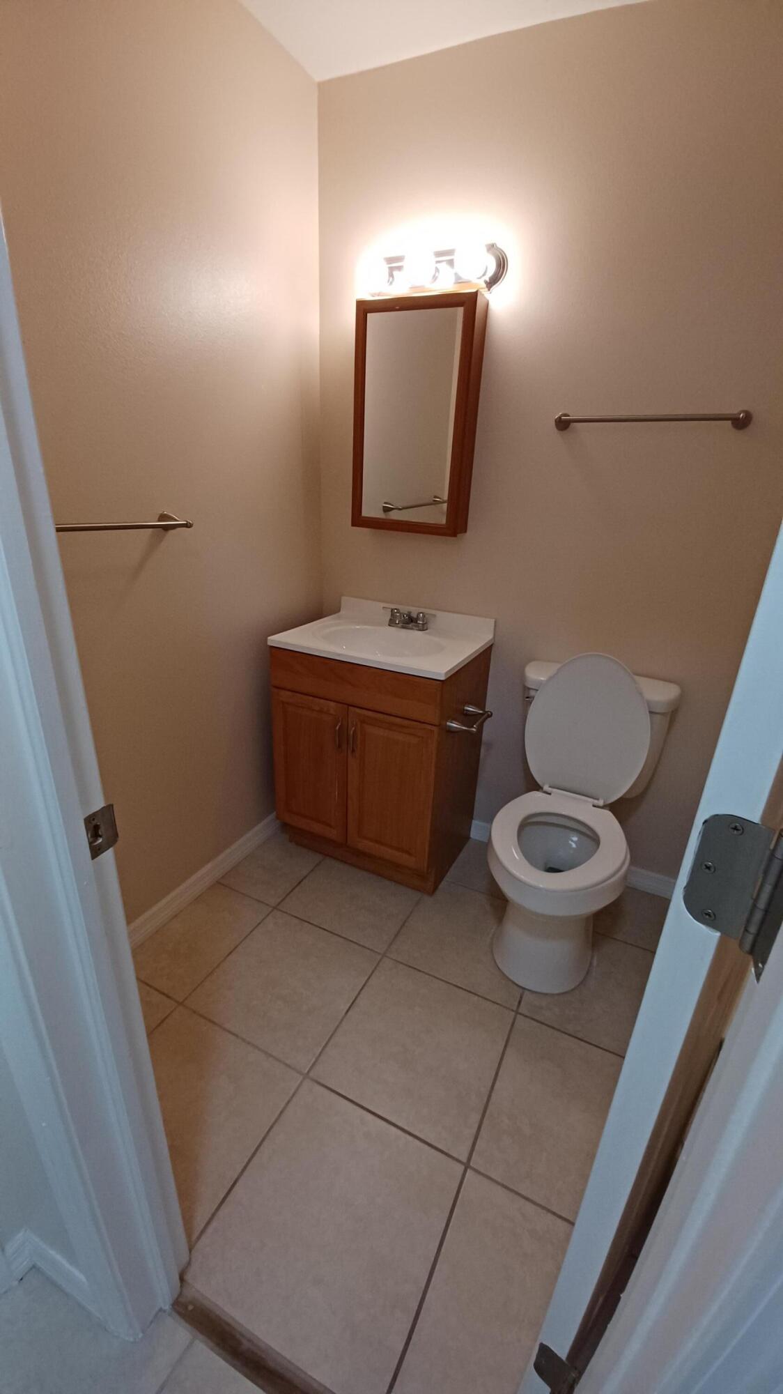 280 Ulster Lane Melbourne, FL 32935 - Photo 13 of 34 a bathroom with a toilet and a mirror