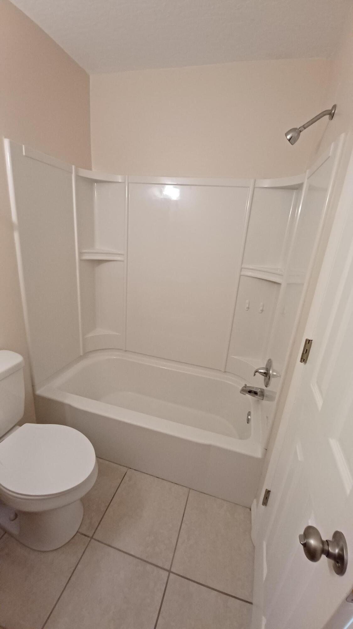 280 Ulster Lane Melbourne, FL 32935 - Photo 14 of 34 a bathroom with a bathtub and a toilet