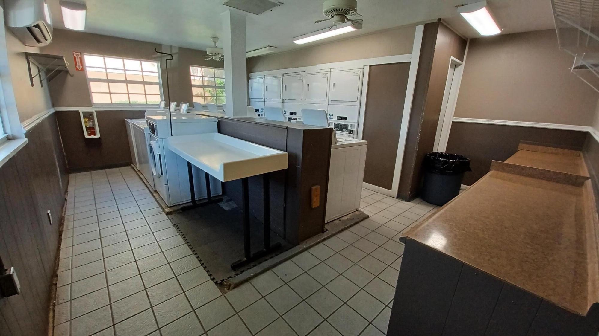 280 Ulster Lane Melbourne, FL 32935 - Photo 24 of 34 a kitchen with stainless steel appliances a sink a refrigerator a counter top space and cabinets