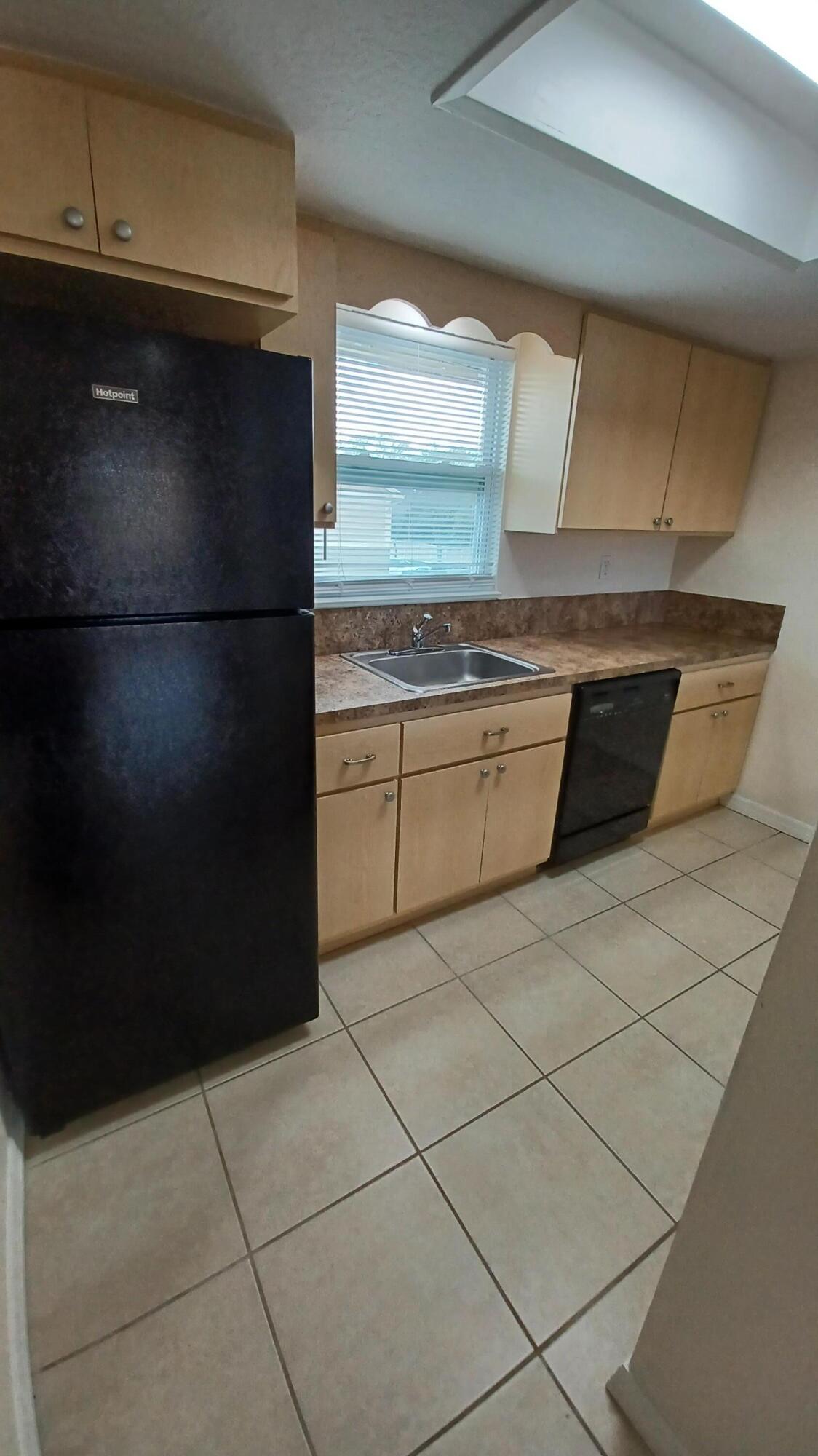 280 Ulster Lane Melbourne, FL 32935 - Photo 7 of 34 a kitchen with granite countertop a refrigerator and a stove