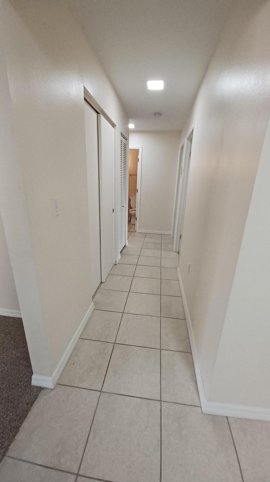 280 Ulster Lane Melbourne, FL 32935 - Photo 8 of 34 a view of hallway with white walls