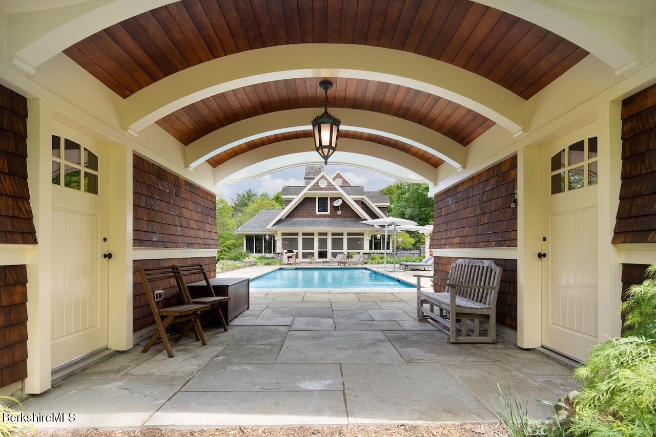 50 E Road Alford, MA 01266 - Photo 18 of 60 a view of a patio with a table and chairs under an umbrella