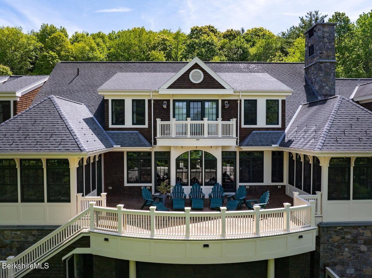 50 E Road Alford, MA 01266 - Photo 24 of 60 a view of a white house with large windows and a small yard